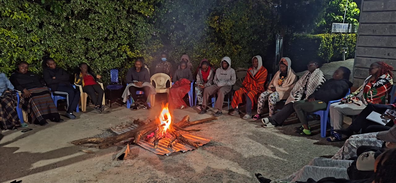 CMC fellowship around the fire in Machakos
